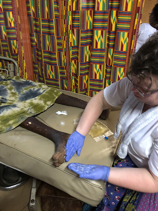 CCH RN Delora Schmidt Africa 2018 rubbing feet nursing